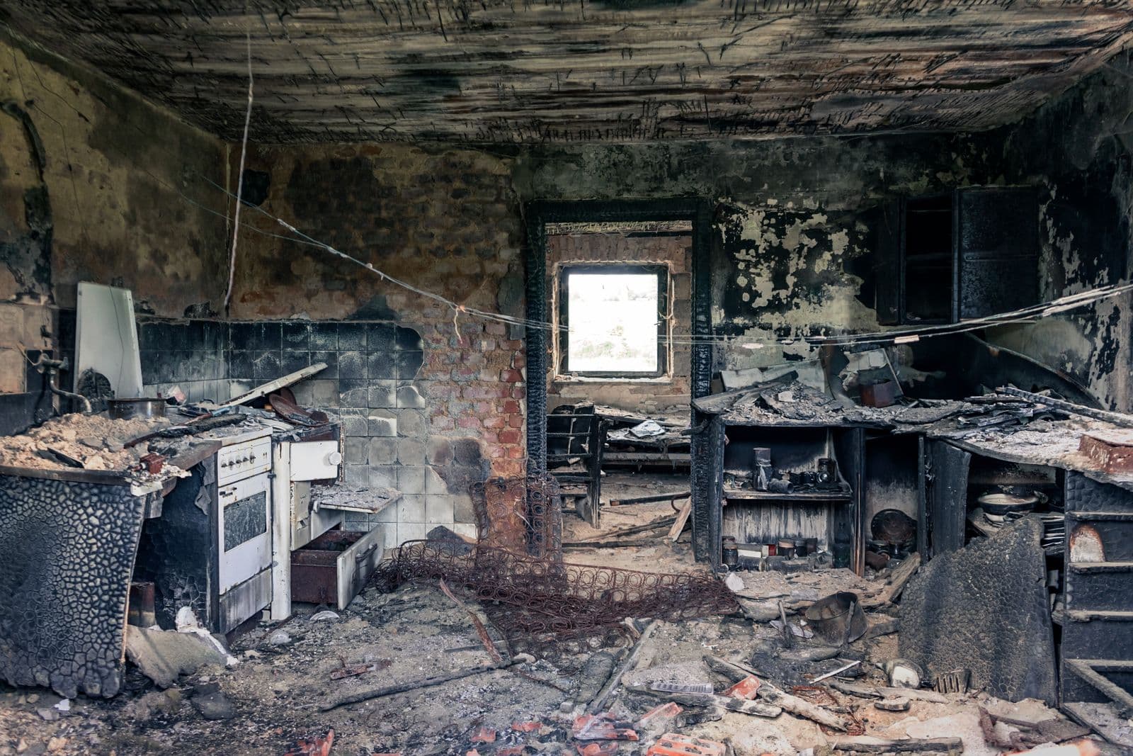 Before: Room interior blackened by fire with soot and debris